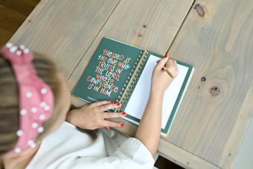 Teen girl writing in spiral-bound Prayer Journal for Teen Girls, with motivational scripture quote and lined page for personal reflection