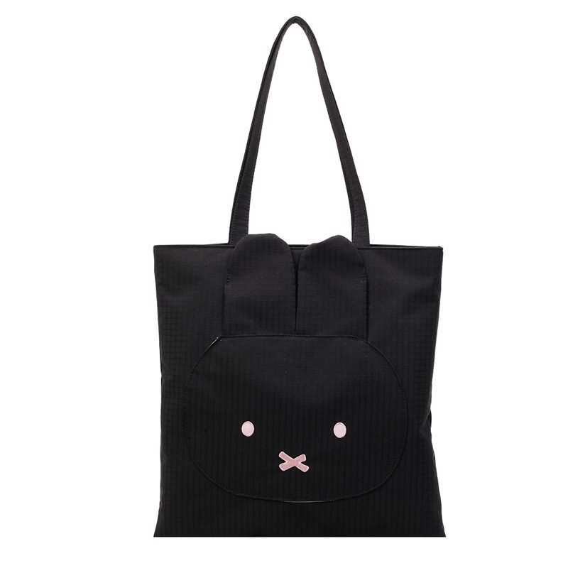 Black Miffy rabbit tote bag with pink cheeks, black eyes, and "X" mouth.